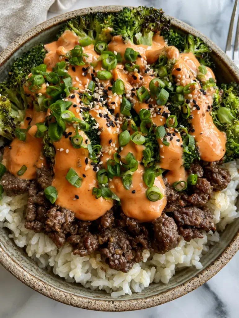 Beef and Broccoli Bowls with Creamy Sriracha Mayo and Jasmine Rice 2 Gourmet ground beef and broccoli rice bowl with vibrant green charred broccoli and glistening beef crumbles. (beef and broccoli bowls)