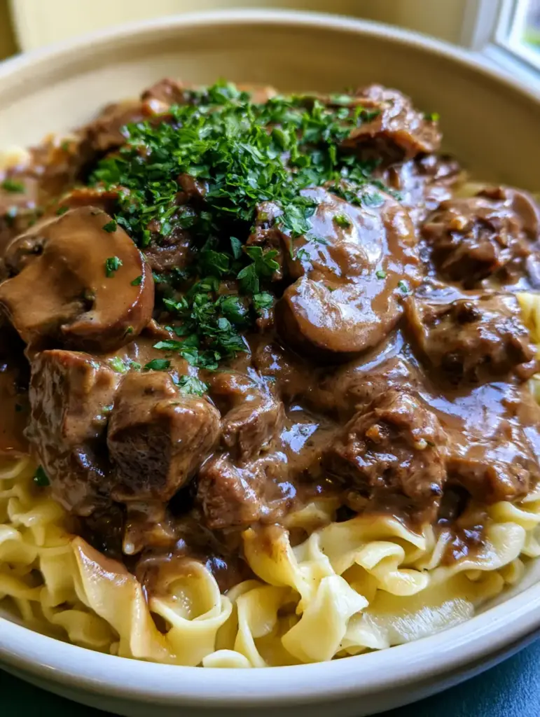 Beef Stroganoff with Fork-Tender Chuck Roast and Velvety Cream Sauce 1 Fork-tender chunks of beef chuck roast in a rich stroganoff sauce with a heavy dusting of bright green parsley.